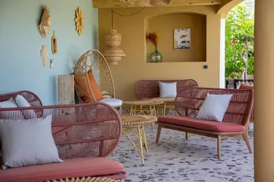 a room with couches and tables and chairs at Hotel Riva Beach in Porto-Vecchio
