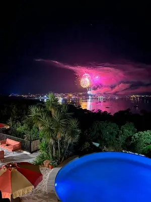 a firework display in the sky over the water at night at Hotel Riva Beach in Porto-Vecchio