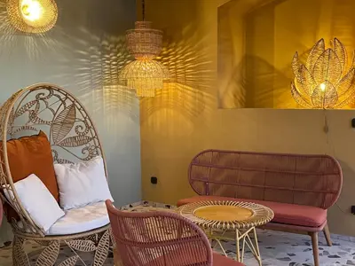 a room with two chairs and a table and a couch at Hotel Riva Beach in Porto-Vecchio