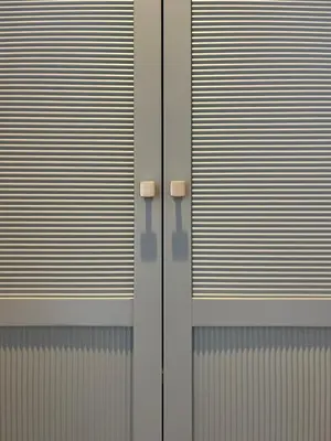 a facade of a building with blinds on the windows at Hotel Riva Beach in Porto-Vecchio