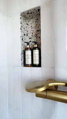 two bottles ofodorizers sitting on a shelf in a bathroom at Hotel Riva Beach in Porto-Vecchio