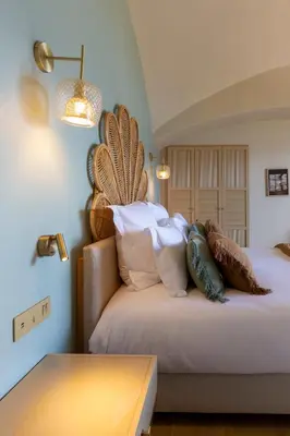 a bedroom with a large bed with pillows on it at Hotel Riva Beach in Porto-Vecchio