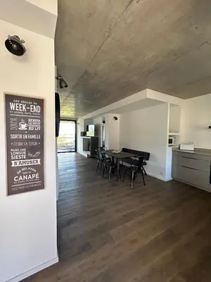a dining room with a table and chairs in a room at Appartements Les Lofts de Sainte-Lucie-de-Porto-Vecchio in Sainte-Lucie de Porto-Vecchio