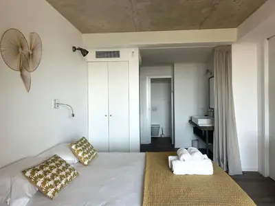 a bedroom with a bed with two towels on it at Appartements Les Lofts de Sainte-Lucie-de-Porto-Vecchio in Sainte-Lucie de Porto-Vecchio