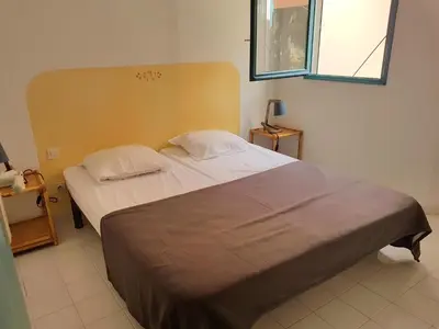 a bedroom with a large bed with two pillows at ST CYPRIEN D29 -4/5 pers- à 250m de la plage de sable Saint Cyprien in Lecci