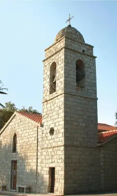 a stone church with a cross on top of it at VILLA LE CORAIL ROUGE CORSE in Lecci