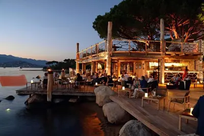 a beach with people swimming in the water at VILLA LE CORAIL ROUGE CORSE in Lecci