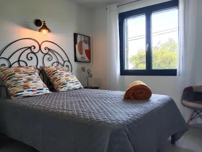 a bedroom with a bed and a window at SANTA-LUCIA in Santa-Lucia-di-Moriani
