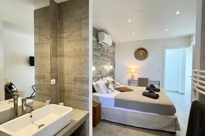 a bedroom and a bathroom with a bed and a tub at Villa Leccia vue mer piscine chauffée Bonifacio in Bonifacio