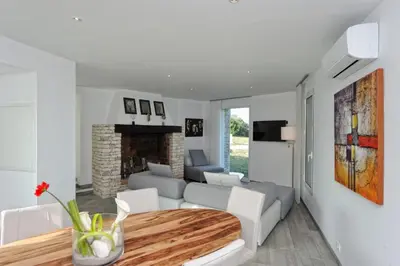 a living room with a couch and a table at Villa Leccia vue mer piscine chauffée Bonifacio in Bonifacio