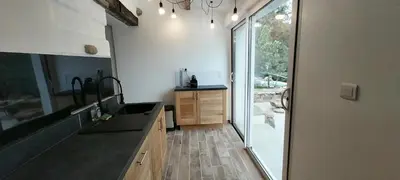 a kitchen with a sink and a large window at Villa A Volta in Urtaca
