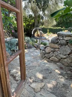 a view of a garden through a window at Villa A Volta in Urtaca