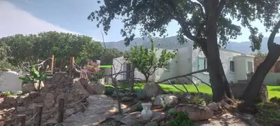 a rock garden in front of a house at Villa A Volta in Urtaca