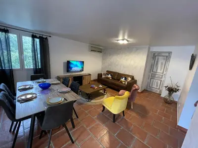 a living room with a table and a couch at Villa A Volta in Urtaca