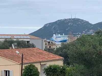 a cruise ship is docked on a hill at Trés Bel appartement de 105 M2 et 45 M2 de terrasse à 100 m du port in Porto-Vecchio