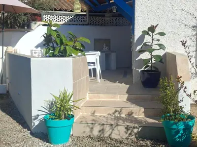 two chairs and a wooden table with a table and two chairs at Piccula Casa in Albitreccia