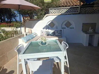 a table and two chairs sitting on a patio at Piccula Casa in Albitreccia