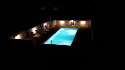 an overhead view of a swimming pool at night at Les bougainvilliers in Penta-di-Casinca