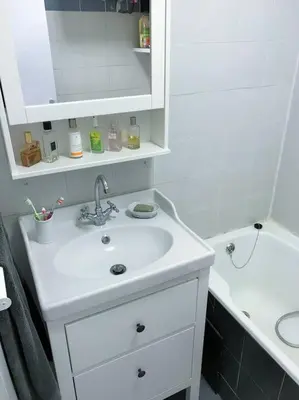 a white bathroom with a sink and a tub at Charmant T3 Centre ville Corté in Corte