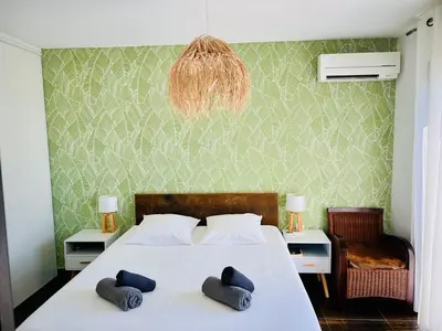 a bedroom with a bed with two pillows on it at Villa Livia Porticcio piscine 500m plage in Porticcio