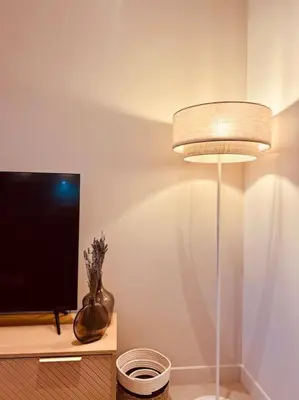 a room with a lamp and a tv and a vase at Villa Livia Porticcio piscine 500m plage in Porticcio