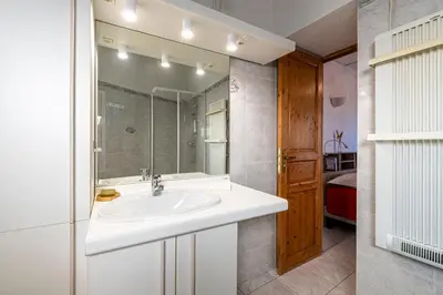 a bathroom with a sink and a mirror at Alla Casa - Appt pour 6 avec terrasse in Aregno