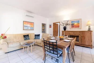 a living room with a table and a couch at Alla Casa - Appt pour 6 avec terrasse in Aregno