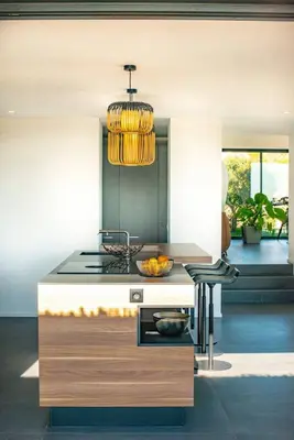 a kitchen with a stove and a chandelier at VILLA ISULA BELLA in Porto-Vecchio