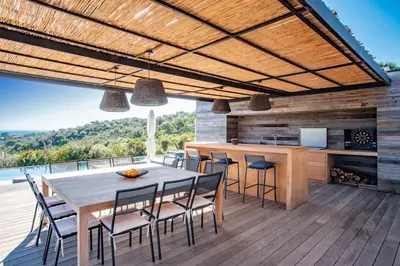a kitchen and dining room with a table and chairs at VILLA ISULA BELLA in Porto-Vecchio
