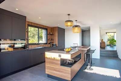 a kitchen with a island in the middle of a room at VILLA ISULA BELLA in Porto-Vecchio