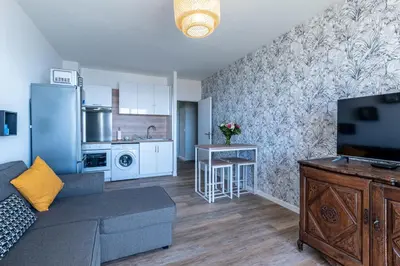 a living room with a couch and a kitchen at Chapelle des Grecs - 1km de la plage in Ajaccio