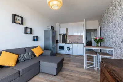 a living room with a couch and a kitchen at Chapelle des Grecs - 1km de la plage in Ajaccio