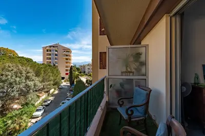 a balcony with a chair and a view of a street at Chapelle des Grecs - 1km de la plage in Ajaccio