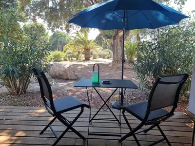 a table and two chairs with a blue umbrella at Fiori di flore in Lecci
