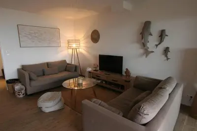 a living room with two couches and a television at Ajaccio maison bord de mer dans résidence avec piscine in Ajaccio