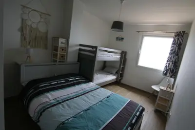 a small bedroom with a bed and a window at Ajaccio maison bord de mer dans résidence avec piscine in Ajaccio
