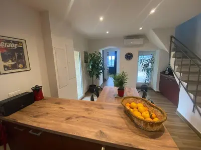 a kitchen with a table with a basket of oranges at Maison de caractère, Zilia, au pied du Montegrossu in Zilia