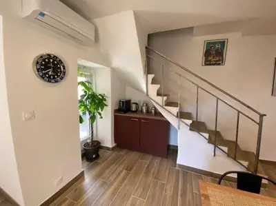a staircase in a living room with wooden floors at Maison de caractère, Zilia, au pied du Montegrossu in Zilia