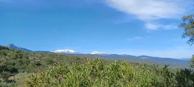 a view of mountains with snow capped mountains in the background at U CASEDDU- Villa piscine privée chauffée- vue mer- clim-wifi in Sari Solenzara