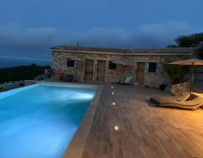 a villa with a swimming pool in front of a house at U CASEDDU- Villa piscine privée chauffée- vue mer- clim-wifi in Sari Solenzara