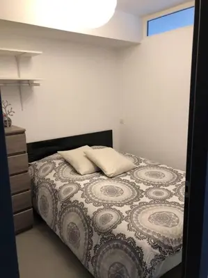 a bedroom with a bed with two pillows on it at T2 récent climatisé à 100m du port in Propriano