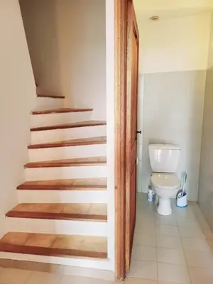 a bathroom with a staircase leading to a toilet at Maison Les couchants Porticcio in Porticcio