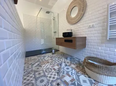 a bathroom with a tile floor and a mirror at Villa d'Architecte Casa Mado avec Piscine vue imprenable in Ajaccio