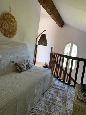 a bedroom with a bed in a room with a window at VILLA Bord de Mer in Cervione