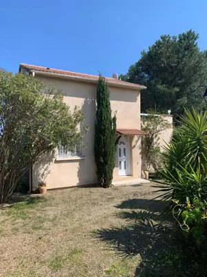 a house with a large yard in front of it at VILLA Bord de Mer in Cervione
