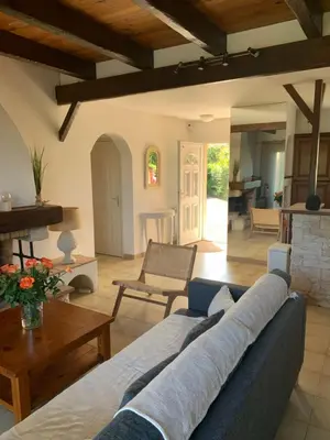 a living room with a blue couch and a table at VILLA Bord de Mer in Cervione