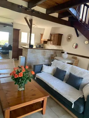 a living room with a couch and a table at VILLA Bord de Mer in Cervione