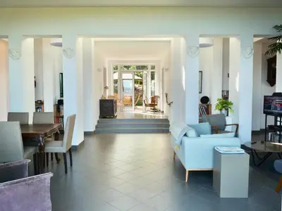 a living room with a blue couch and chairs at Corse Piana villa d’architecte vue exceptionnelle in Piana