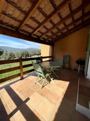 a patio with a table and chairs on a balcony at Résidence Kallisté in Sollacaro