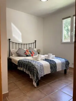 a bedroom with a bed with a blanket on it at Résidence Kallisté in Sollacaro